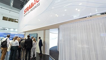 A well-attended panel discussion directly at the booth, showcasing the high level of interest and active audience engagement from trade fair visitors.