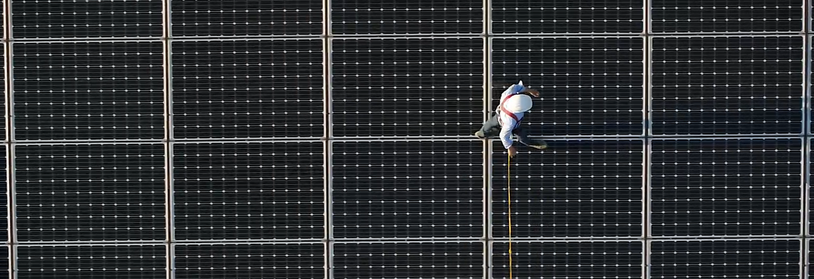 Man walks on solar pannels 