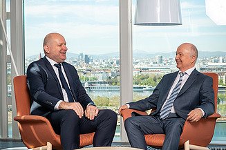 2 Managers behind a scenic View of Vienna, Donau 